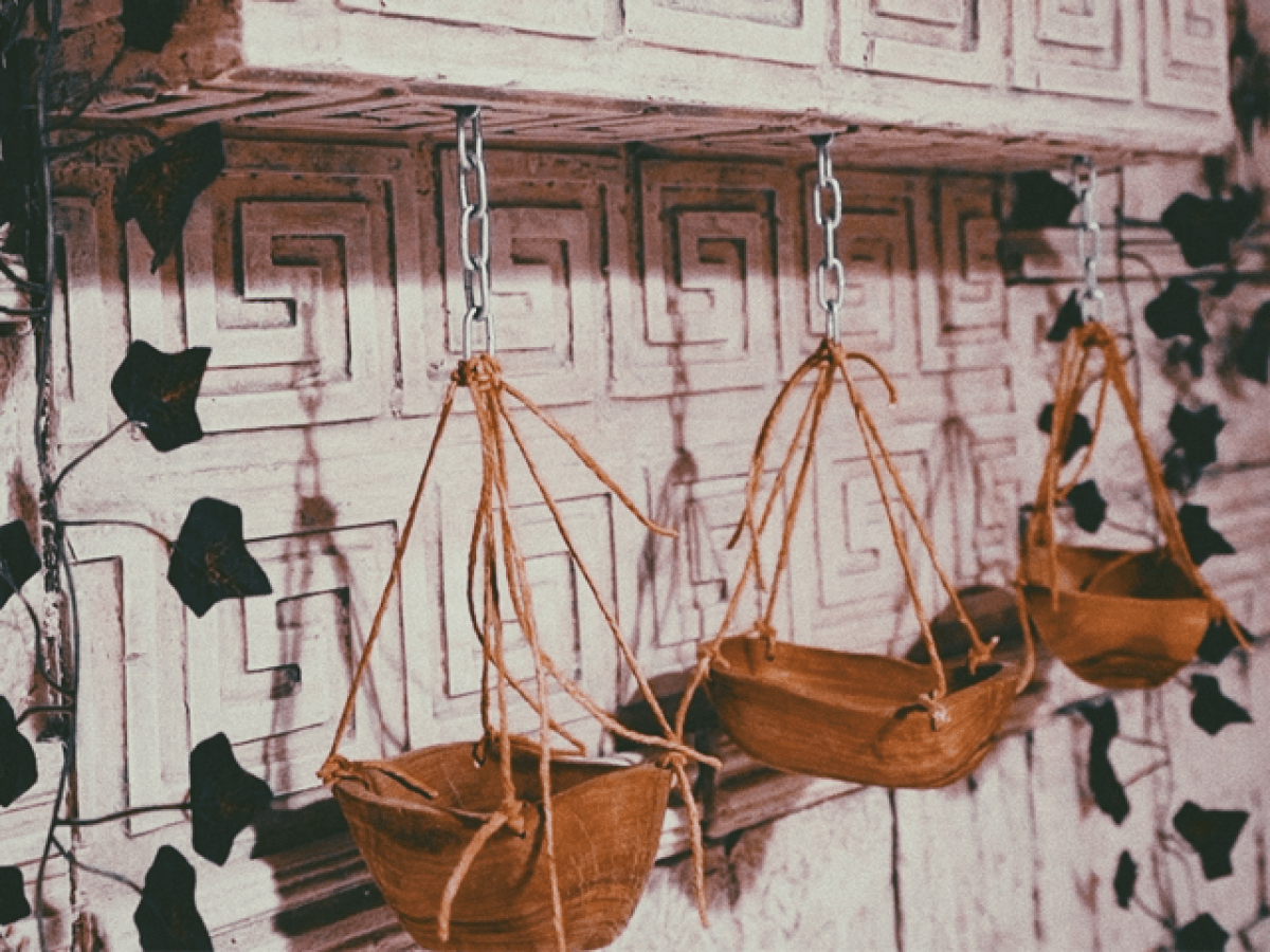 a vase of flowers sitting on top of a wooden chair