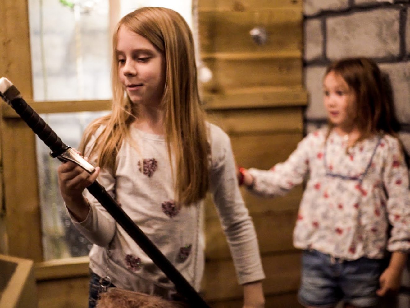 a little girl standing in front of a building